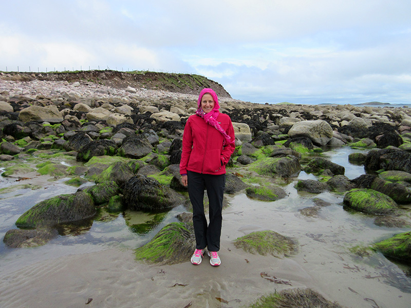 Christi with mossy rocks on an Achill Island beach